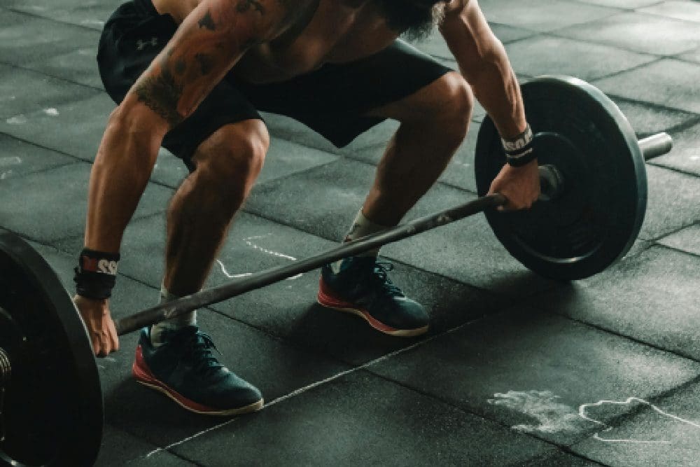 A man is lifting some weight in the gym